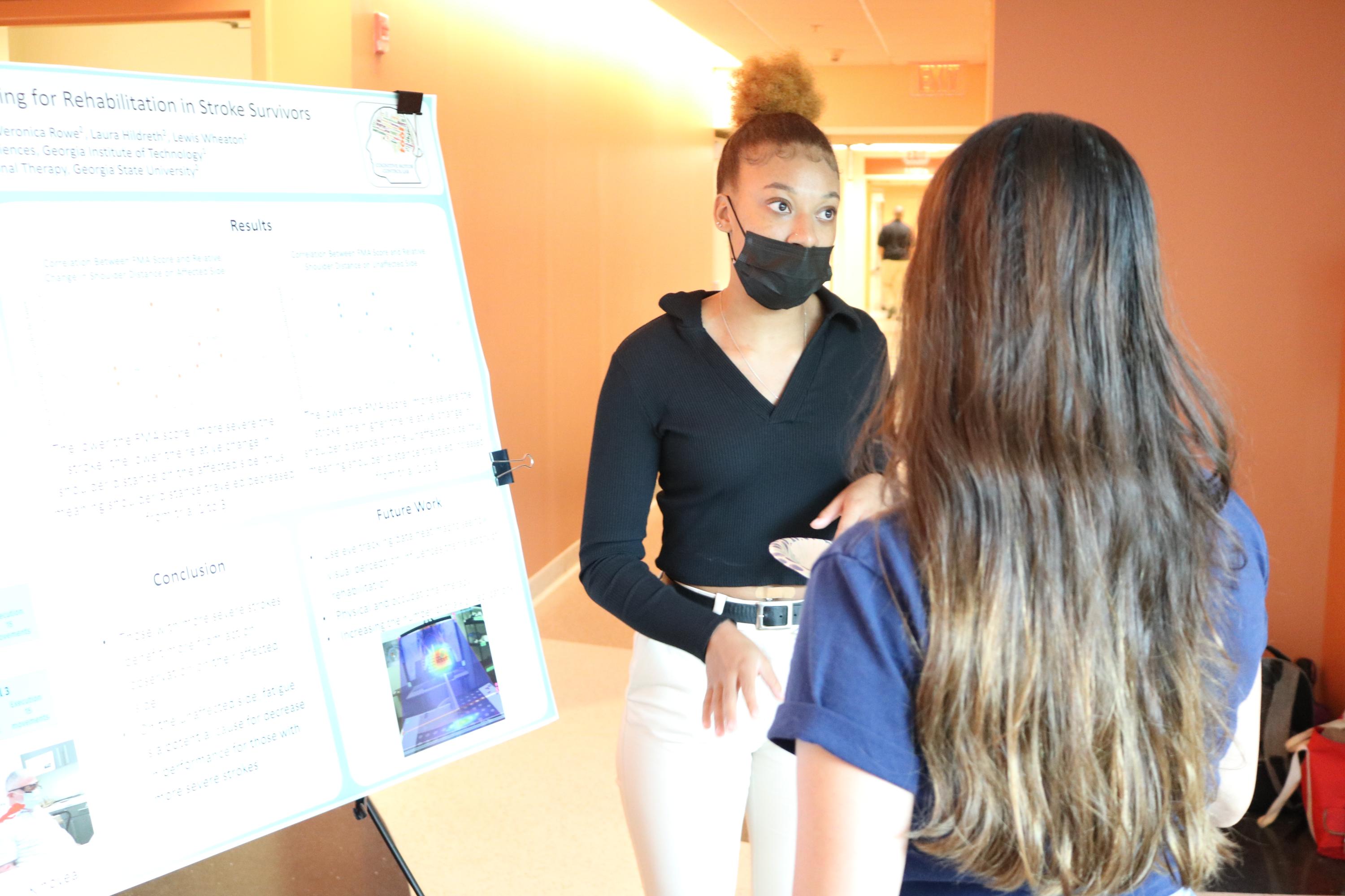 Alexa Toliver, fourth-year student at Arizona State University, explains her neuroscience research during the summer 2022 Research Experience for Undergraduates. (Photo Renay San Miguel)