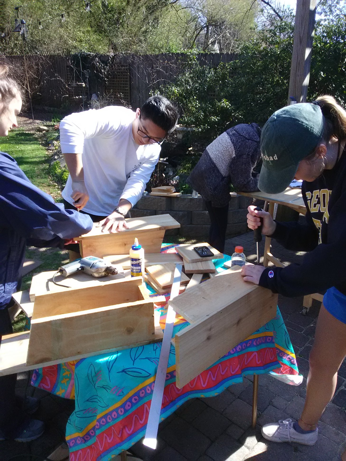 Students from Teresa Snow's AAPH 1040: Scientific Foundations of Heath class, help with birdhouse construction for Walter's Woods near East Decatur Greenway.