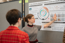 Gretchen Johnson explains her research to a judge during the competition.