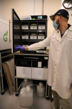  TipCycle project manager Adam Fallah demonstrates how Grenova's pipette tip washing system operates.