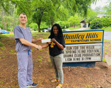 Brookhaven Family Dentistry owner Dr. Andrew Kokabi presents Huntley Hills Elementary Principal Mia Ford with a check from his practice's "Brighten Your Smile, Better Your World" campaign. (Photo Brookhaven Family Dentistry) 